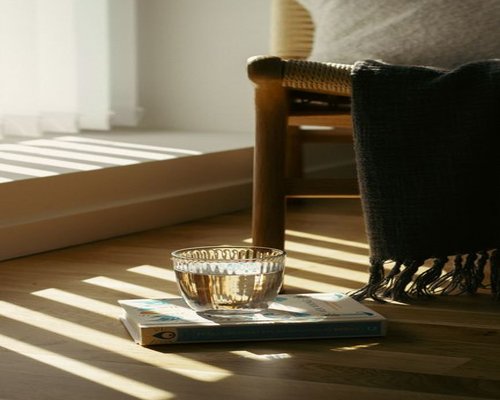 A glass of fresh water and a book on a comfortable resting chair